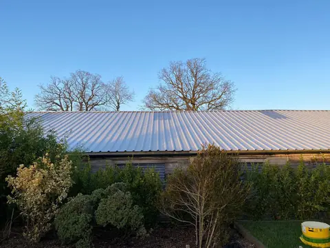 The same roof after re-sheeting in light grey profiled steel